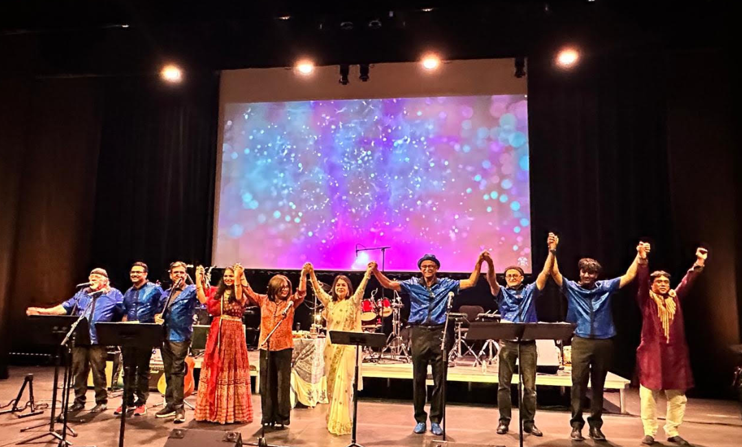 Chili Beatz taking a bow, hands raised together, at the end of a packed-house show at the Scherr Forum Theater in Thousand Oaks